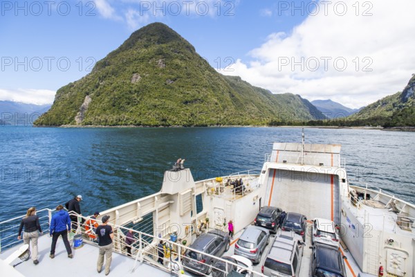 Passengers view the mountains and fjord landscape on the car ferry between Hornopirén and Caleta Gonzalo, Los Lagos region, Patagonia, Chile, South America