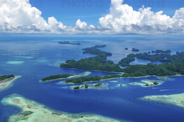 Aerial view of 70 Rock Islands green islands in island paradise island state Palau in the Pacific West Pacific, in the background white clouds Cumulus, Republic of Palau, Micronesia, Australia, Oceania
