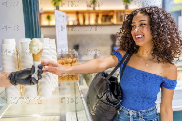 Side view of a happy latin beauty woman shopping ice cream cone at store
