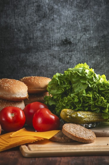 Fresh ingredients for a hamburger, including lettuce, tomatoes and bun