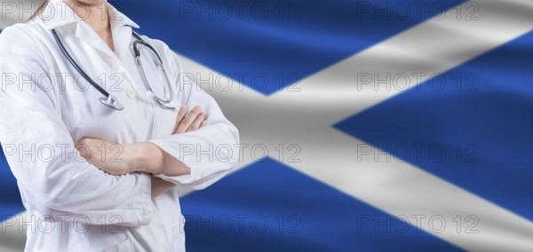 Doctor with crossed arms on Scottish flag. Scotland health and care concept. Female doctor on Scottish flag