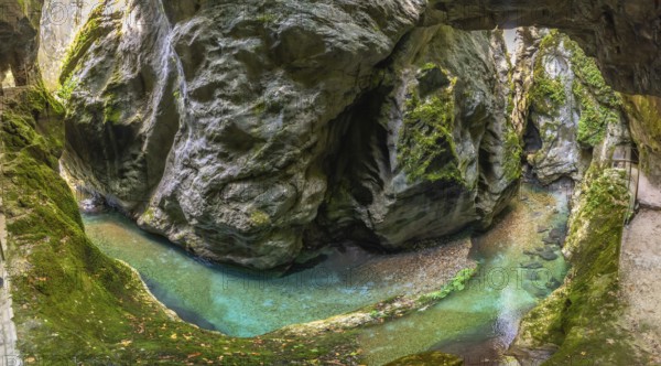Scenic landscape showing tolmin gorges carving through rock formations with crystal clear turquoise water flowing through the canyon