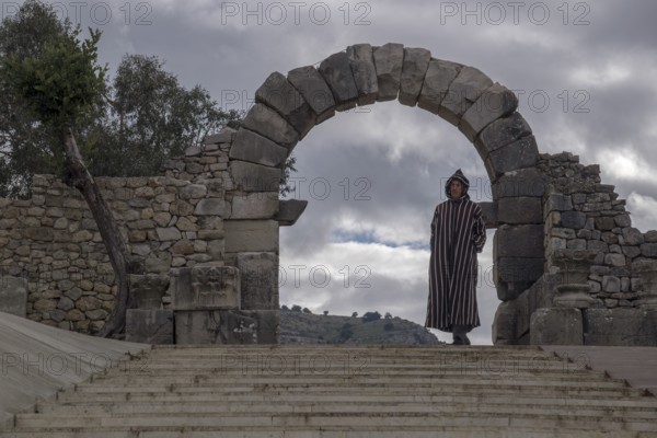 Man with djellab in the ruins of Volubilis, UNESCO World Heritage Site, Mulay Idris, Meknes, Morocco, Africa