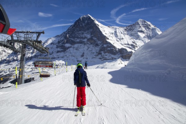 25 March 2024: Skiing against the backdrop of the north face of the Eiger in Grindelwald, Switzerland, Europe