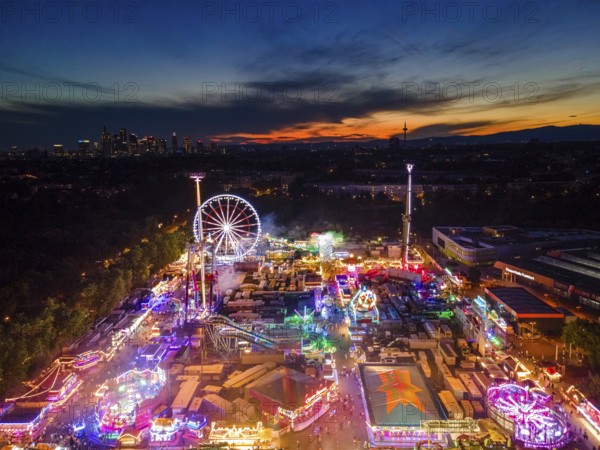 The lights of the Dippemess in Frankfurt am Main glow after sunset. Aerial view, ice rink, Frankfurt am Main, Hesse, Germany, Europe