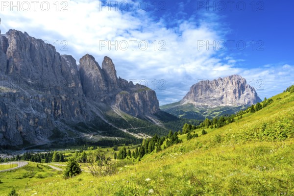 Majestic peaks and lush meadows create a stunning panorama in the heart of the italian dolomites, along the scenic gardena pass during a sunny summer day