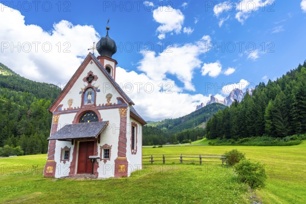 Scenic view of the st. Magdalena church with the odle mountains in the background, a popular tourist destination in the italian dolomites