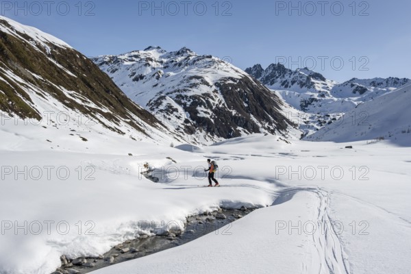 Ski tourers on the Graubünden Haute Route in the Val Susauna mountain valley, snow-covered mountains, winter in the Albula Alps, Graubünden, Switzerland, Europe