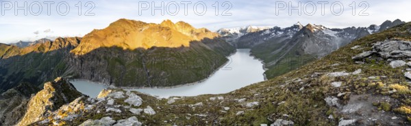 Picturesque mountain landscape at the summit Mont de la Blana at sunset, view of blue mountain lake, reservoir Lac des Dix and summit Mont Blanc de Cheilon with glacier, Hérémence, Valais, Western Alps, Switzerland, Europe
