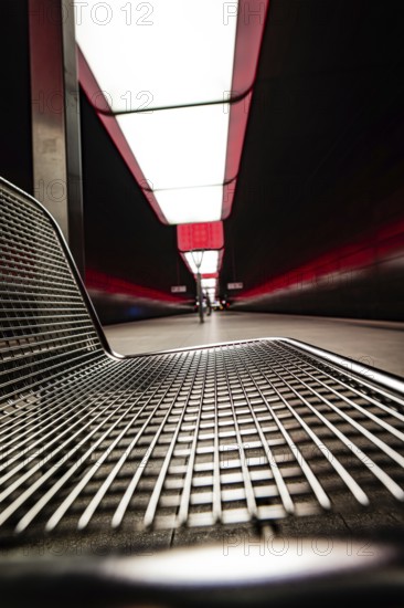 Modern underground station with metal bench and red lighting effects, Hafencity University, Hamburg, Germany, Europe
