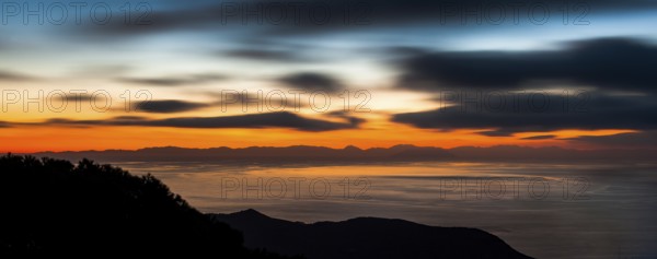 Atmospheric view with colourful evening sky shortly after sunset from Tuscan island Giglio to the west over Thyrrenian Sea Mediterranean Sea on island Corsica, Giglio, Tuscany, Italy, Europe