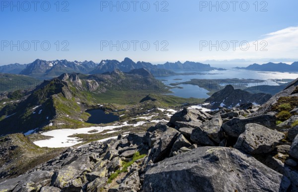 View of mountains and fjord landscape, mountain panorama, mountaineer at the summit of Rundfjellet, lake Hellskarvatnet and fjord Austnesfjorden, Svolvaer, Nordland, Norway, Europe