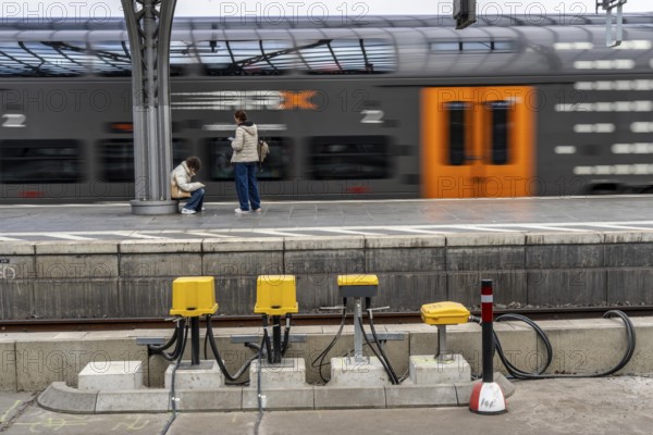 Digitalisation at Deutsche Bahn, in the yellow cable protection and distribution boxes the data cables from various sensors, such as axle counters, signals, points, RFID recording devices, etc., converge on the tracks, from here they are sent to the digital interlocking technology to record data for controlling rail traffic, Cologne, North Rhine-Westphalia, Germany, Europe
