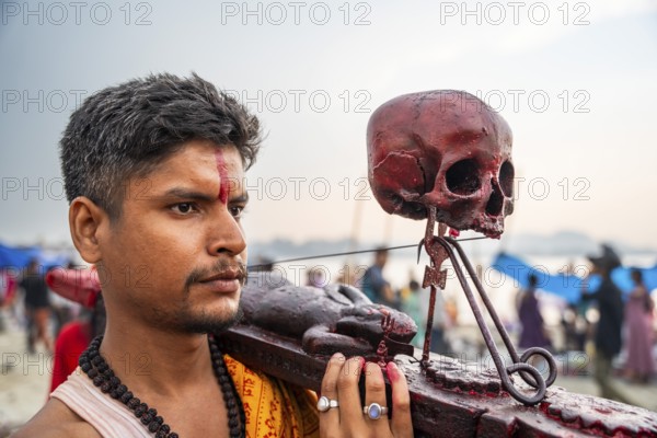 A Hindu priest arrives awith a human skull on the bank of Brahmaputra river on Ashoka Ashtami Festival during Chaitra Navratri on April 5, 2025 in Guwahati, India, Asia