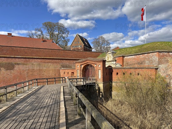 Historic brick fortress with bridge and flag under a blue sky with clouds, Fortress, Dömitz, Mecklenburg-Vorpommern, Germany, Europe