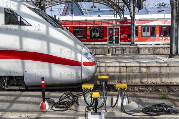 Digitalisation at Deutsche Bahn, in the yellow cable protection and distribution boxes the data cables from various sensors, such as axle counters, signals, points, RFID recording devices, etc., converge on the tracks, from here they are sent to the digital interlocking technology to record data for controlling rail traffic, Cologne, North Rhine-Westphalia, Germany, Europe