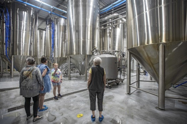 Covington, Louisiana - The Abita Brewing Company's craft beer brewery. A tour guide explains the brewing process to visitors