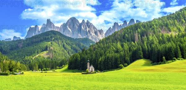 Scenic landscape featuring the st. Magdalena church nestled in a vibrant green valley with the majestic odle mountain range in the background