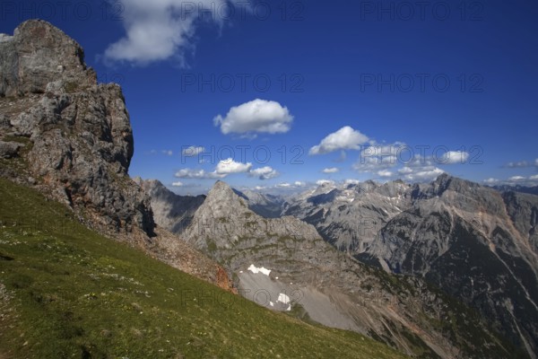 Fascinating view of high mountain peaks and clouds under a blue sky, Karwendel, Mittenwald, Bavaria, Germany, Europe