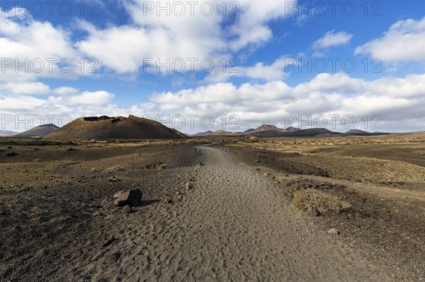 Hiking trail to the volcanic crater Caldera de Los Cuervos, lava fields, Los Volcanes nature park Park, Tias, Yaiza, Lanzarote, Spain, Europe