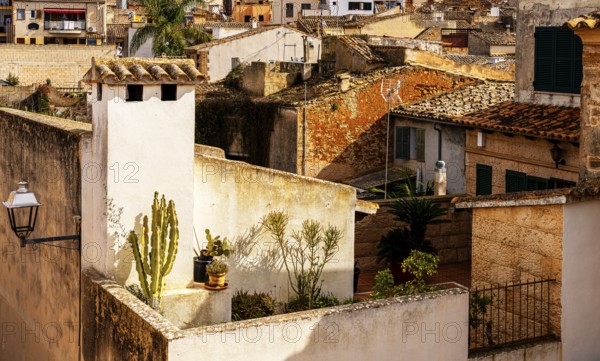 View of Mediterranean houses, roofs and courtyards from the town wall, Alcudia, Majorca, Spain, Europe