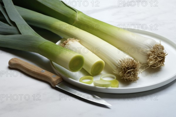 Leek, leek sticks on plate with knife, leek