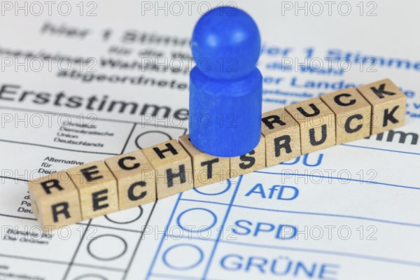 Symbolic image of the shift to the right in Germany: Symbolic ballot paper with letter cubes and a blue figure symbolising the AfD
