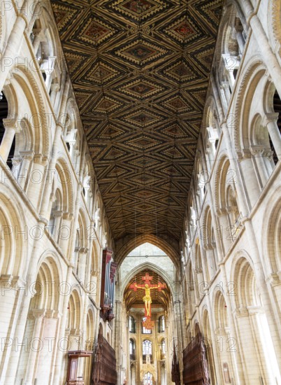 Interior of cathedral church, Peterborough, Cambridgeshire, England, UK looking up at ceiling and sculpture of Jesus Christ on Cross
