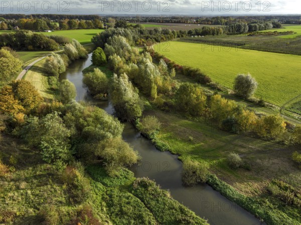 Bergkamen, Ruhr area, North Rhine-Westphalia, Germany, autumn landscape on the Seseke. The renaturalised Seseke, a tributary of the Lippe, has been transformed into a near-natural watercourse, flood protection and biodiversity through newly designed floodplains. Following the construction of a parallel sewer, the Seseke is now free of wastewater, having previously been an open, above-ground wastewater sewer, combined sewer with surface water and wastewater. Theme photo: EU Nature Conservation Act. The EU Nature Conservation Act obliges member states to implement measures to restore nature on at least 20 per cent of the EU's land and sea areas by 2030, Europe