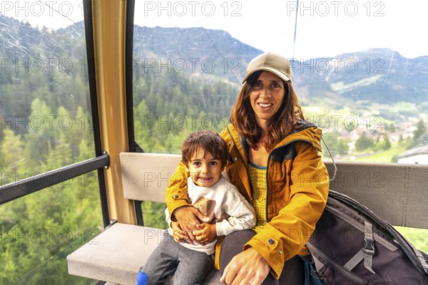 Tourists enjoying a scenic cable car ride in the italian dolomites, taking in the breathtaking mountain views