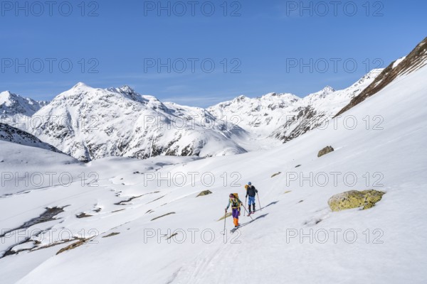 Two ski tourers in a mountain landscape with snow, behind Piz Müsella, ascent to Grialetsch Scharte, Bündner Haute Route, Albula Alps, Rhaetian Alps, Grisons, Switzerland, Europe