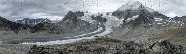 Aerial view, Alpine panorama, hiker at the summit, mountain landscape with glacier Glacier de Cheilon and summit Mont Blanc de Cheilon, Valais, Western Alps, Switzerland, Europe