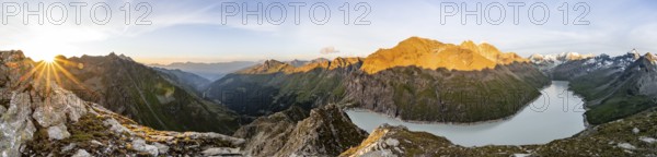 Panorama, Picturesque mountain landscape at the summit Mont de la Blana at sunset, view of blue mountain lake, reservoir Lac des Dix and summit Mont Blanc de Cheilon with glacier, Sun Star, Hérémence, Valais, Western Alps, Switzerland, Europe