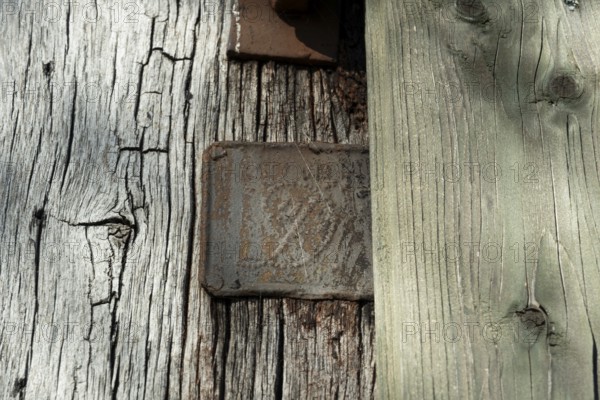 An old rusty hidden tin sign on a half-timbered barn, Wildeshauser Geest, Bassum, Diepholz, Lower Saxony, Germany, Europe