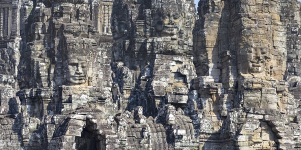 Panoramic image of giant stone-carved faces of the Bodhisattva Lokeshvara, also known as Avalokiteshvara, Bayon Temple, Angkor Thom, UNESCO World Heritage Site, Angkor Wat, Siem Reap, Cambodia, Asia