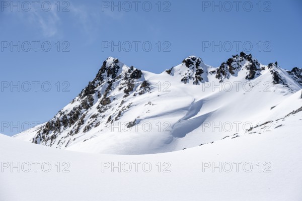Minimalist winter landscape, white snow and dark mountains on the Scalettahorn, Graubünden, Switzerland, Europe