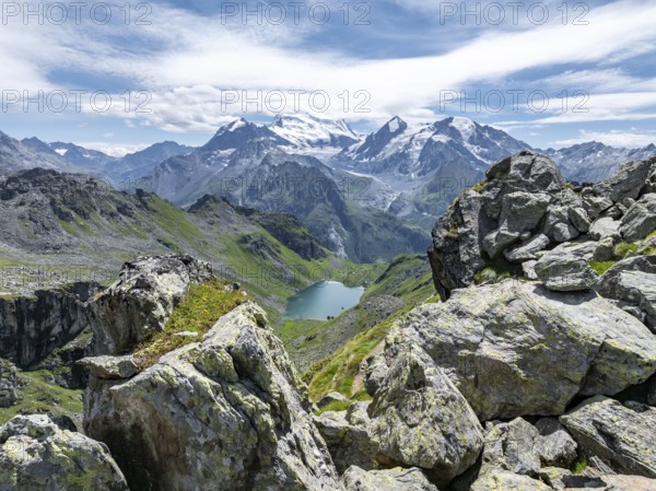 Mountain stream and mountain lake Lac de Louvie with glaciated summit of the Grand Combin, Val de Bagnes, Valais, Switzerland, Europe