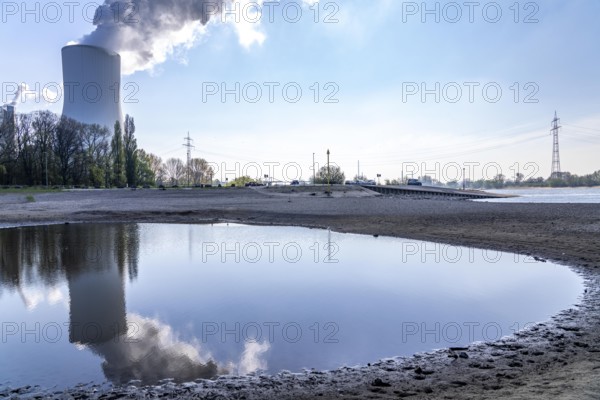 Low water level on the Rhine, after the driest and warmest March since weather records began, the banks are dry, shipping can only navigate with reduced cargo and speed, Duisburg-Walsum, cooling tower of the STEAG Walsum cogeneration plant, North Rhine-Westphalia, Germany, Europe