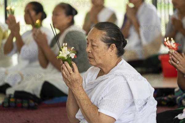 NAMSAI, INDIA.- APRIL 16: Devotees celebrate the vibrant Sangken Festival at Golden Pagoda in Namsai, India on 16 April 2025. Sangken Festival is a beautiful and culturally rich water festival celebrated primarily by the Theravada Buddhist communities, it marks the Buddhist New Year, typically falling in mid-April