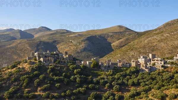 Historic village on sunlit hills, Vathia, residential tower village, Mani peninsula, Peloponnese, Greece, Europe