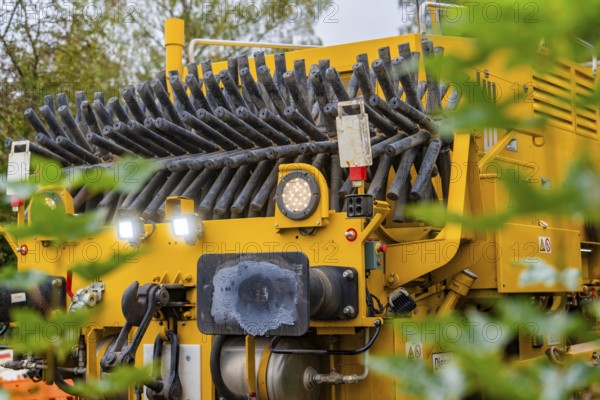 Yellow machine, partly covered by leaves, showing technical details, tamping machine, Hermann Hessebahn, Calw, Black Forest, Germany, Europe