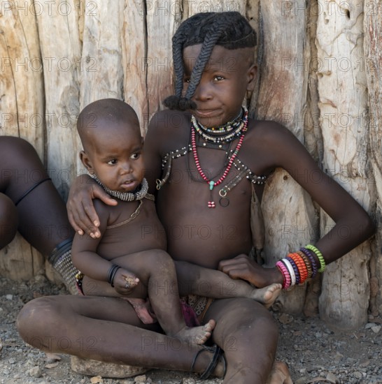 Himba girl with forward braided plaits with baby, near Opuwo, Kaokoveld, Kunene, Namibia, Africa