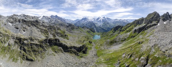 Alpine panorama, aerial view, mountain stream and mountain lake Lac de Louvie with glaciated summit of the Grand Combin, Val de Bagnes, Valais, Switzerland, Europe