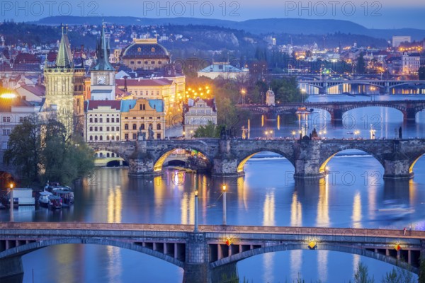 Travel Prague background, elevated view of bridges over Vltava river from Letna Park. Prague, Czech Republic in twilight
