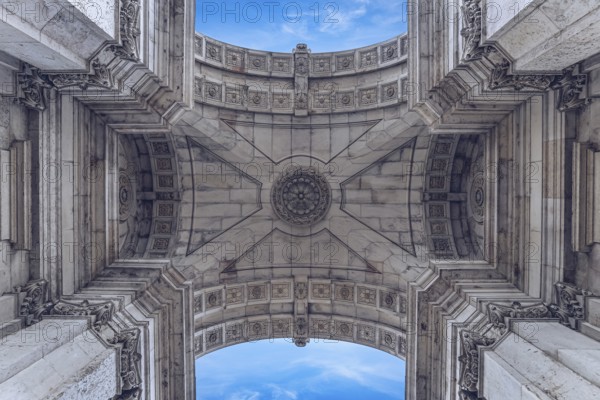 View of ornate stone arch pattern with symmetrical details and clear blue sky in the background, Arco da Rua Augusta, Lisbon, Portugal, Europe