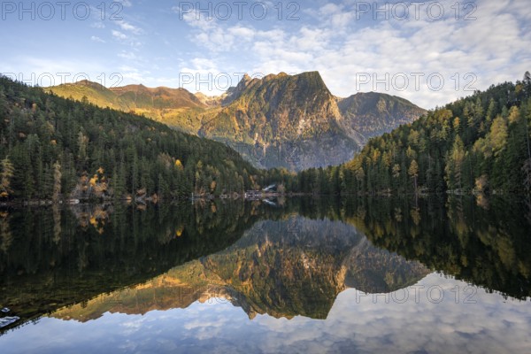 Mountain peaks of the Ötztal Alps reflected in Lake Piburger See, in autumn, near Ötz in Ötztal, Tyrol, Austria, Europe