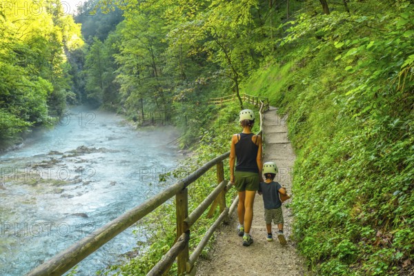 Tourists enjoying a scenic walk through the beautiful vintgar gorge near bled, slovenia, on a summer day