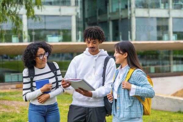Multi-ethnic students reading notes before an exam in the university standing outside the campus