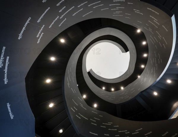 Spiral staircase printed with Finnish words, Oodi Central Library and Cultural Centre, designed by ALA Architects, Helsinki, Finland, Europe