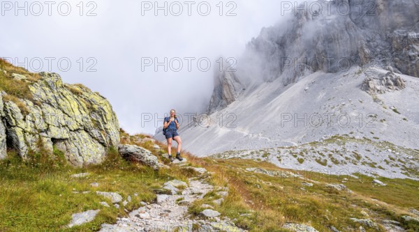 Hiker on the ascent to the Great Kinigat, Carnic Main Ridge, Carnic High Trail, Carnic Alps, Carinthia, Austria, Europe